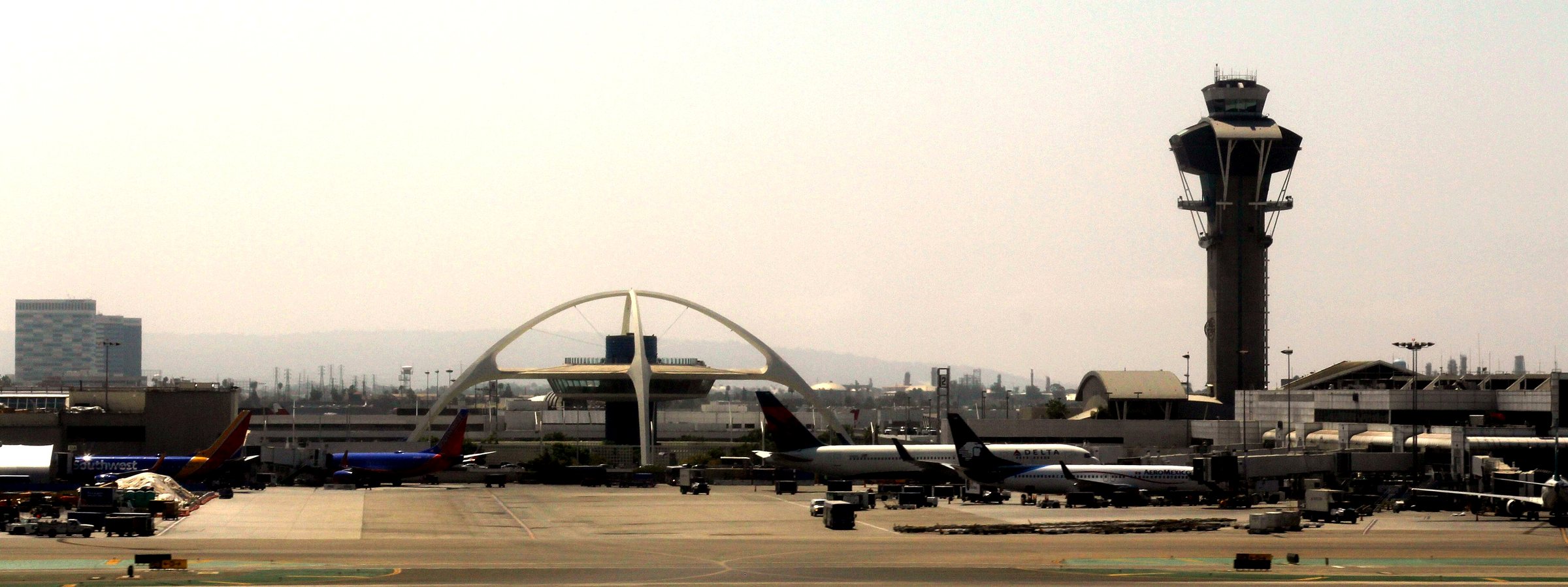LAX airfield with the Theme Building and the LAX control tower, hazy warm sky